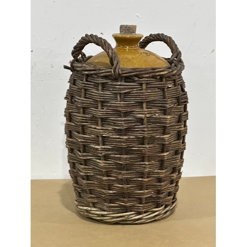 28 - A vintage stone jar in wicker. A.W. Buchan & Co. Portobello. 24x23x40cm