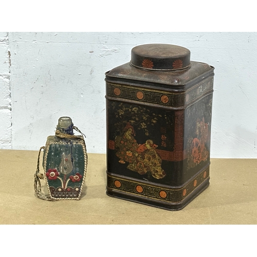 30 - A late 19th century tin canister and a vintage Middle Eastern style bottle. 17x17x30cm