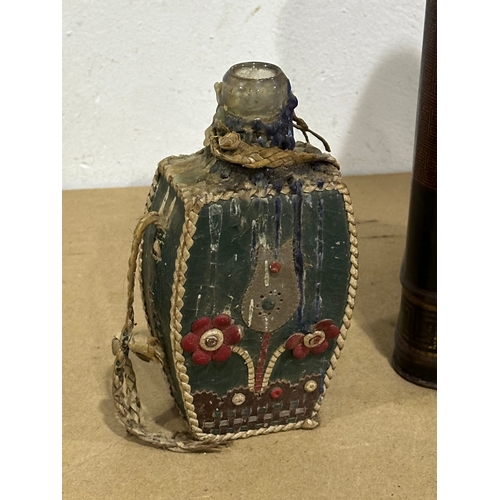 30 - A late 19th century tin canister and a vintage Middle Eastern style bottle. 17x17x30cm