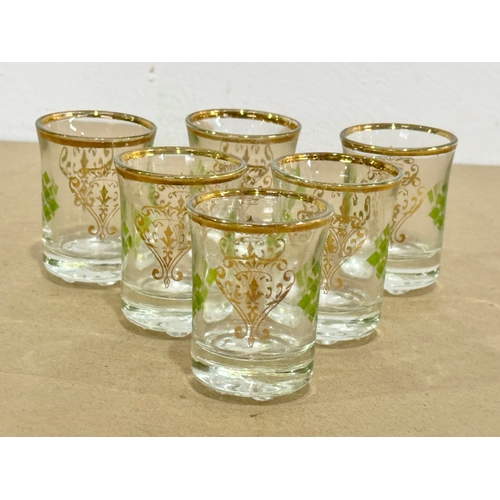 49 - A set of 6 vintage gilt rimmed shot glasses.