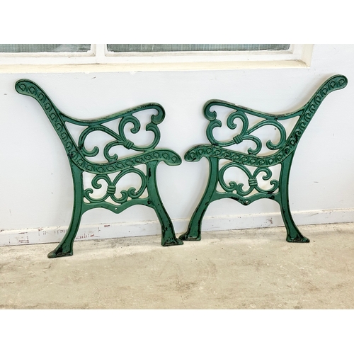 53 - A pair of large cast iron garden bench ends. 67x78cm