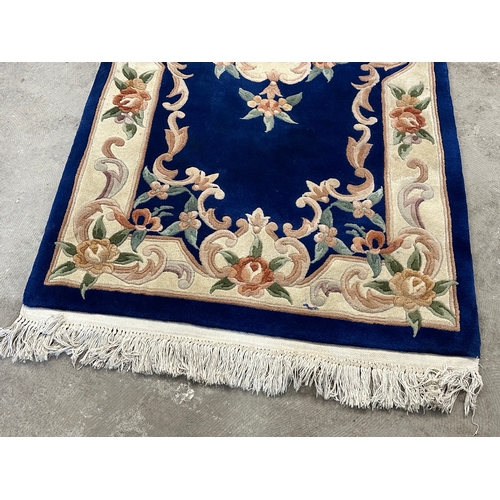 57 - A wool rug. 91x209cm