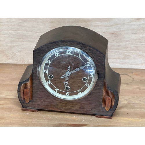 96 - A vintage oak cased mantle clock. Key and pendulum. 28x13x22cm