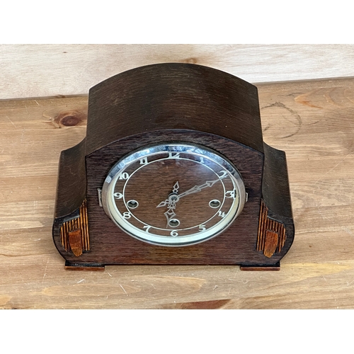 96 - A vintage oak cased mantle clock. Key and pendulum. 28x13x22cm