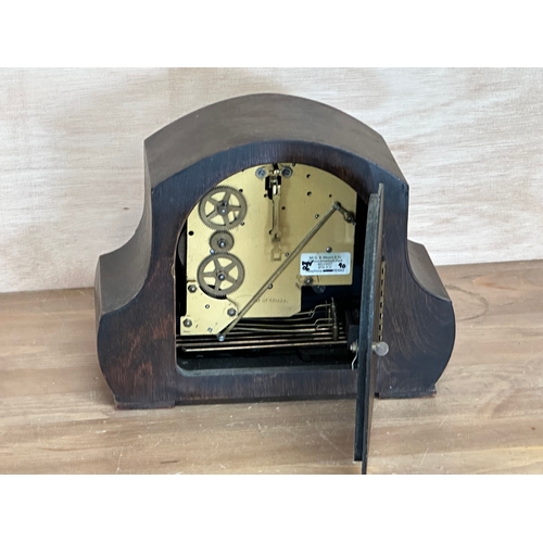 96 - A vintage oak cased mantle clock. Key and pendulum. 28x13x22cm