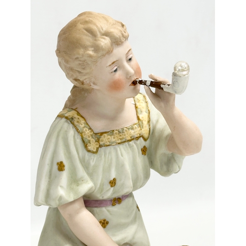 66 - A pair of late 19th century Heubach bisque ‘Bubbles’ figures. Circa 1890. 23cm