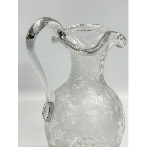 5 - An etched glass pitcher in the manner of William Fritsche. Decorated with leaves, grape vines and bi... 