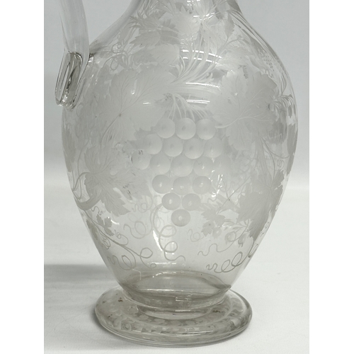 5 - An etched glass pitcher in the manner of William Fritsche. Decorated with leaves, grape vines and bi... 