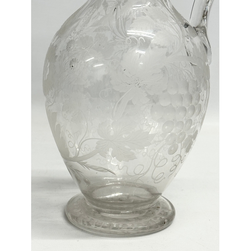 5 - An etched glass pitcher in the manner of William Fritsche. Decorated with leaves, grape vines and bi... 