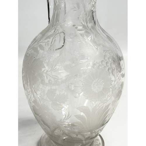 5 - An etched glass pitcher in the manner of William Fritsche. Decorated with leaves, grape vines and bi... 