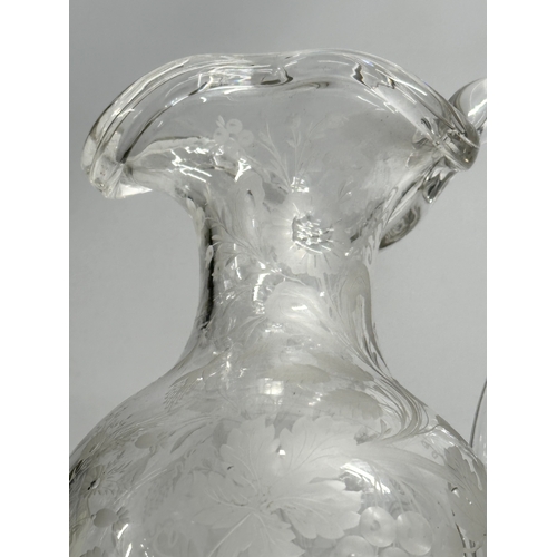 5 - An etched glass pitcher in the manner of William Fritsche. Decorated with leaves, grape vines and bi... 