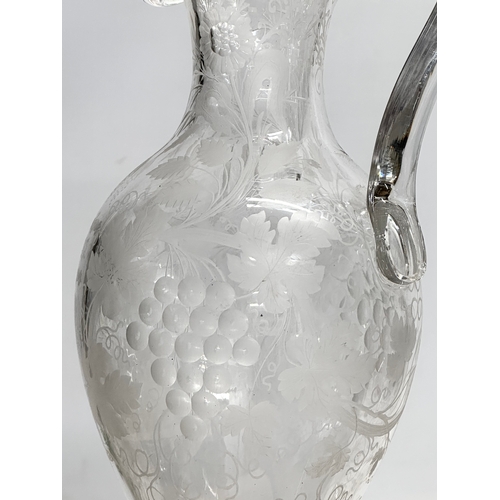 5 - An etched glass pitcher in the manner of William Fritsche. Decorated with leaves, grape vines and bi... 