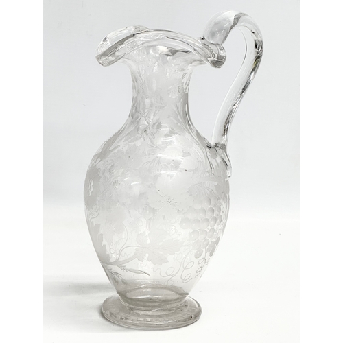 5 - An etched glass pitcher in the manner of William Fritsche. Decorated with leaves, grape vines and bi... 