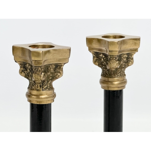 89 - A pair of brass candlesticks with Corinthian column. 16cm