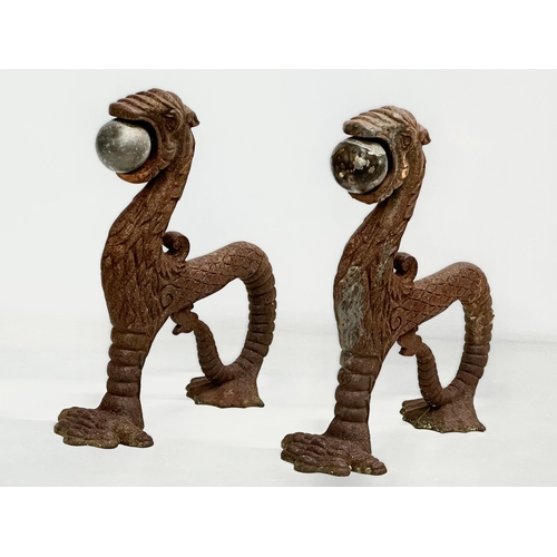 13 - A pair of early/mid 19th century cast iron ‘Sea Lion’ andirons. 23x26cm