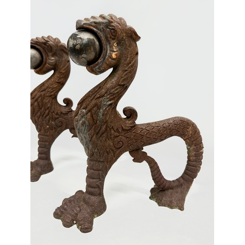 13 - A pair of early/mid 19th century cast iron ‘Sea Lion’ andirons. 23x26cm