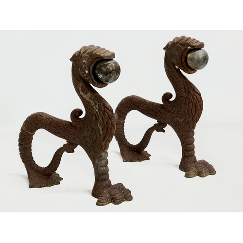 13 - A pair of early/mid 19th century cast iron ‘Sea Lion’ andirons. 23x26cm