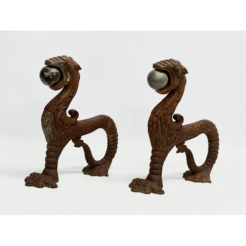 13 - A pair of early/mid 19th century cast iron ‘Sea Lion’ andirons. 23x26cm