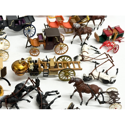 455 - A collection of Brumm horse and carriages.