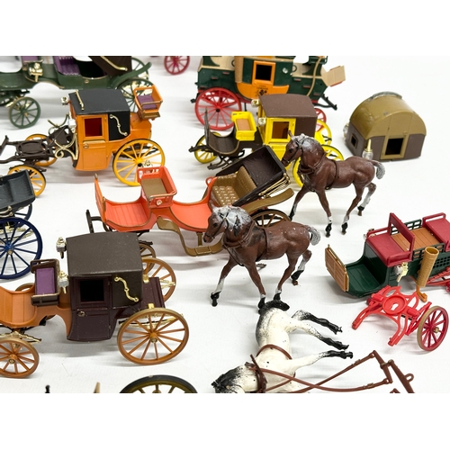 455 - A collection of Brumm horse and carriages.