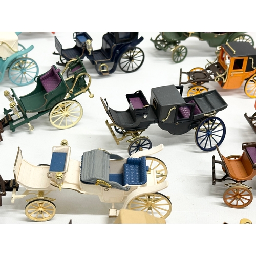 455 - A collection of Brumm horse and carriages.