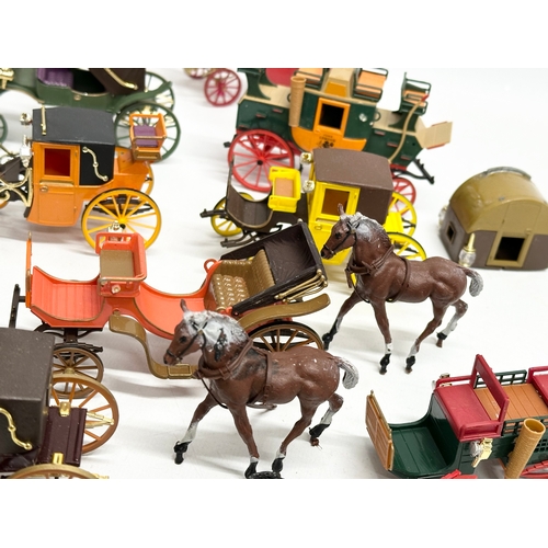 455 - A collection of Brumm horse and carriages.