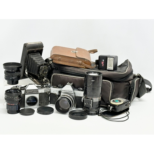 529 - A collection of vintage cameras and lenses. A Praktica MTL 50 camera. A Praktica PL noval camera. A ... 