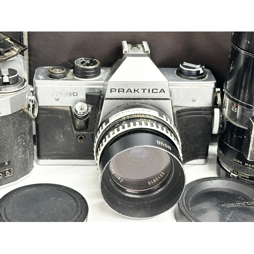 529 - A collection of vintage cameras and lenses. A Praktica MTL 50 camera. A Praktica PL noval camera. A ... 