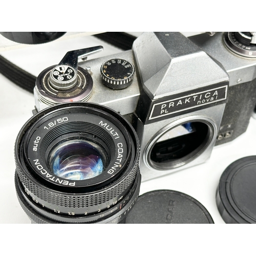 529 - A collection of vintage cameras and lenses. A Praktica MTL 50 camera. A Praktica PL noval camera. A ... 