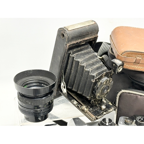 529 - A collection of vintage cameras and lenses. A Praktica MTL 50 camera. A Praktica PL noval camera. A ... 