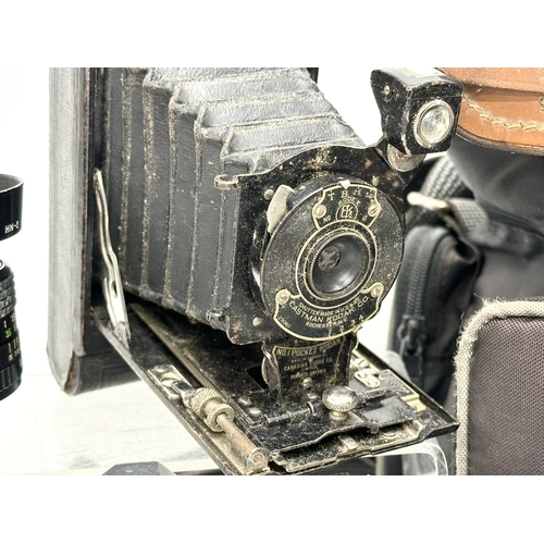 529 - A collection of vintage cameras and lenses. A Praktica MTL 50 camera. A Praktica PL noval camera. A ... 