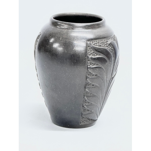 220 - A black glazed ceramic pot by Marginea. 10x14cm