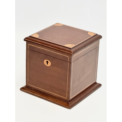 145 - An Edwardian inlaid mahogany tea caddy. 15x15x15cm