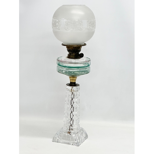 100 - A large Victorian oil lamp with glass column, bowl and etched glass shade. 66cm