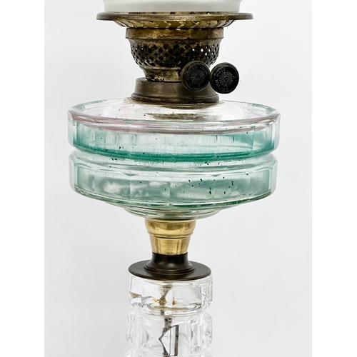 100 - A large Victorian oil lamp with glass column, bowl and etched glass shade. 66cm