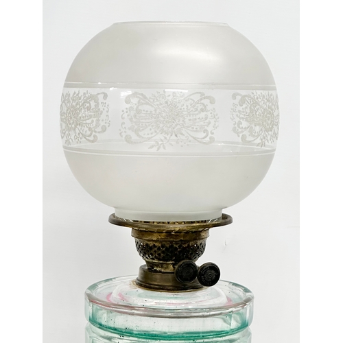 100 - A large Victorian oil lamp with glass column, bowl and etched glass shade. 66cm