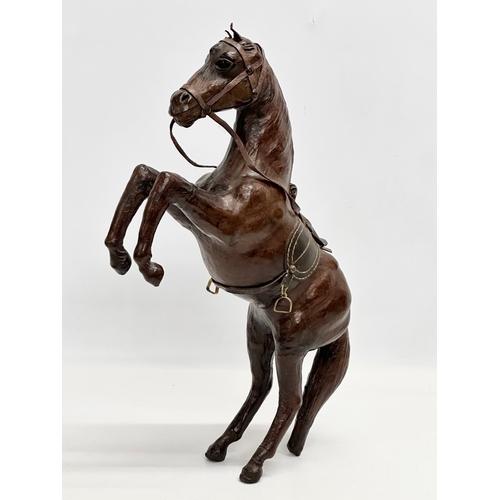 147 - A large early/mid 20th century leather horse. 41cm