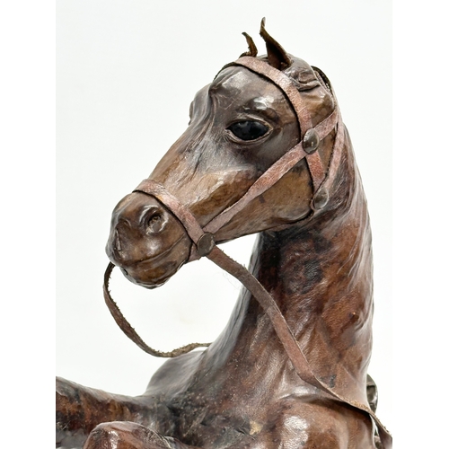 147 - A large early/mid 20th century leather horse. 41cm