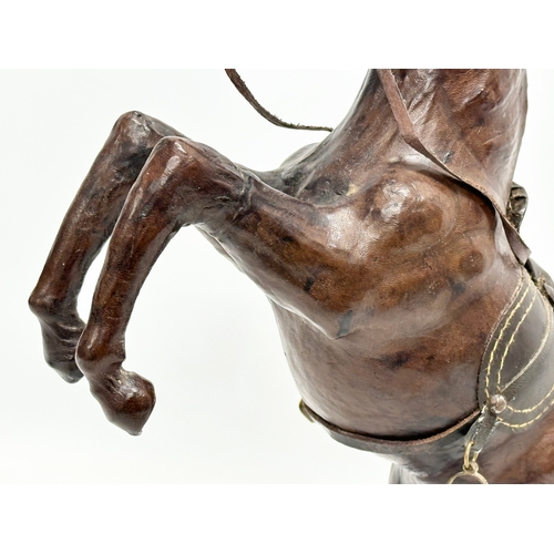 147 - A large early/mid 20th century leather horse. 41cm