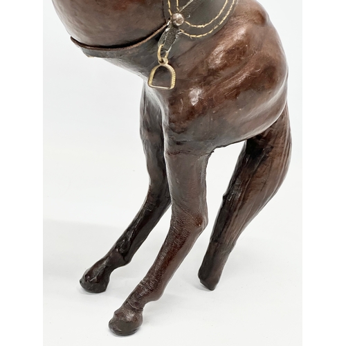 147 - A large early/mid 20th century leather horse. 41cm