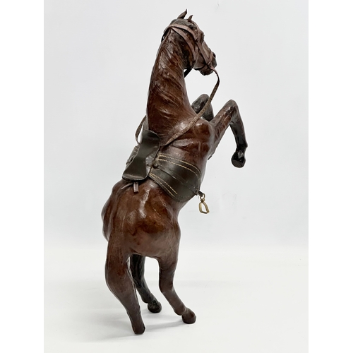 147 - A large early/mid 20th century leather horse. 41cm