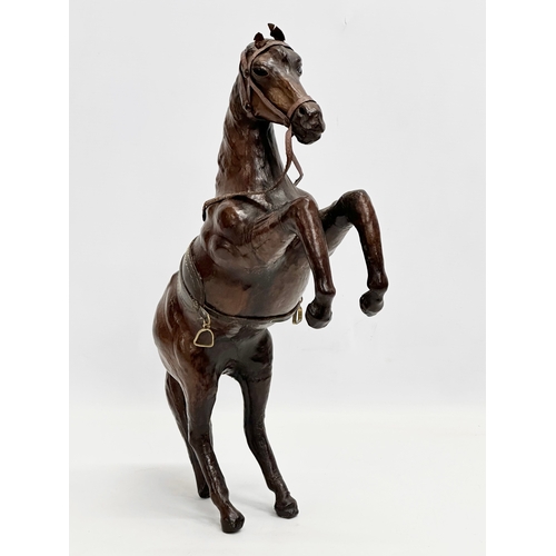 147 - A large early/mid 20th century leather horse. 41cm