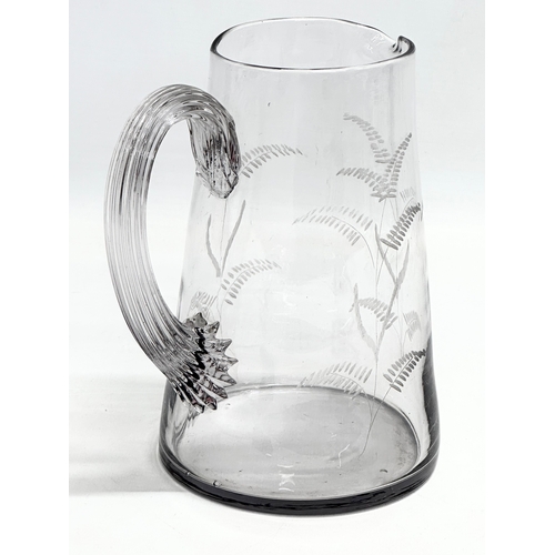 154 - An Edwardian glass water jug with etched ferns. Circa 1900-1910. 16x18.5