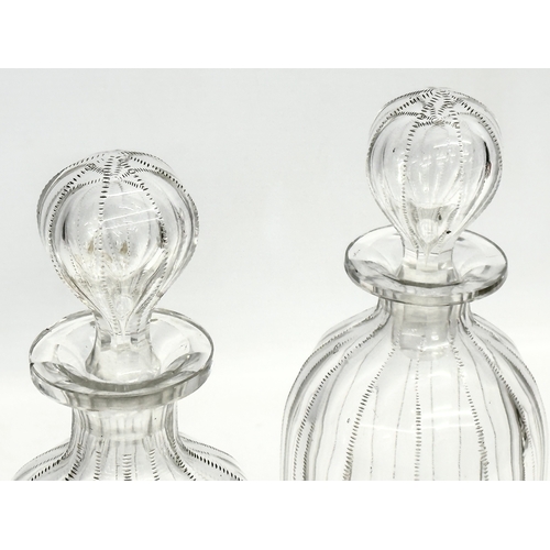 112 - A pair of 19th century Victorian glass decanters with etched wire design. 26.5cm