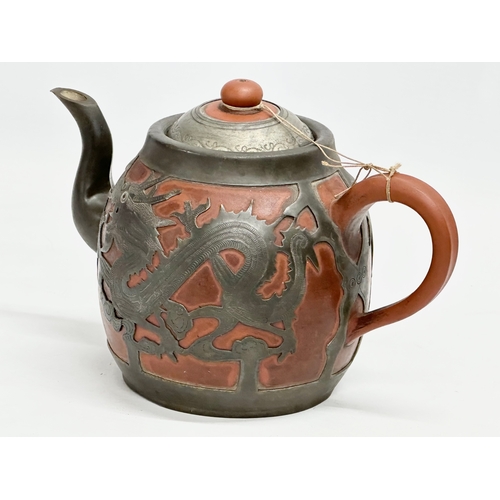 170 - A Chinese “Sunshine Chang” pewter bound terracotta teapot, with dragon design. 20x14cm