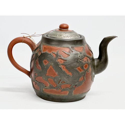 170 - A Chinese “Sunshine Chang” pewter bound terracotta teapot, with dragon design. 20x14cm