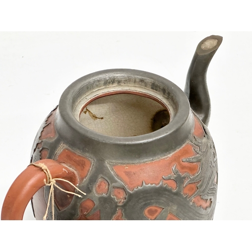 170 - A Chinese “Sunshine Chang” pewter bound terracotta teapot, with dragon design. 20x14cm