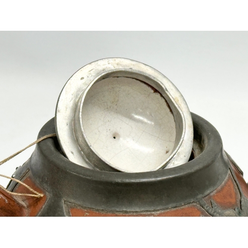 170 - A Chinese “Sunshine Chang” pewter bound terracotta teapot, with dragon design. 20x14cm