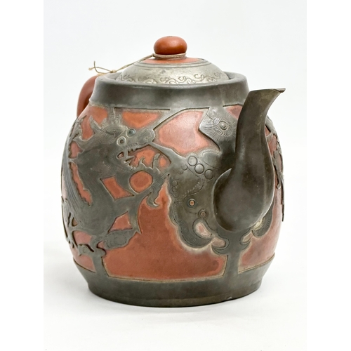 170 - A Chinese “Sunshine Chang” pewter bound terracotta teapot, with dragon design. 20x14cm