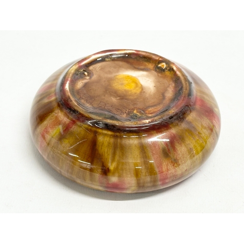 171 - An early 20th century glazed shallow bowl. Ruskin style. 11x3.5cm